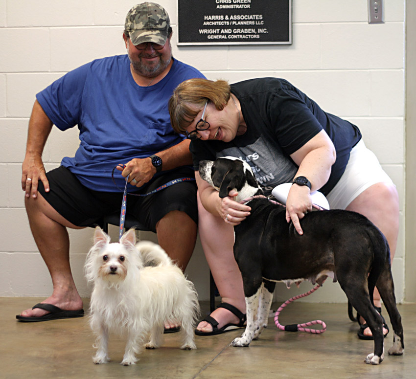 Shawn and Denise, residents of Pinson, came to the Blount County shelter seeking a dog who might be older or who had been overlooked. To make sure the adopted dog would be compatible with their own dog, they brought Tyberius, left, a Cairn Terrier mix they took in after he was abandoned in a dog park. After a first compatibility test with a dog who was perhaps a little too active, big, and playful for the smaller Ty, Tildie had a go. This sweet, quiet girl, probably a Pointer mix, met Ty with curiosity and concern, then quickly warmed up to her soon-to-be pal. Photo by Kristin Yarbrough